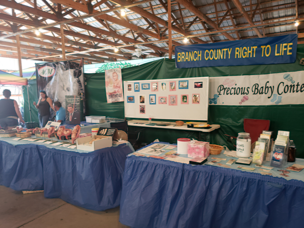 County fair display table showing Branch County Right to Life materials and banner.